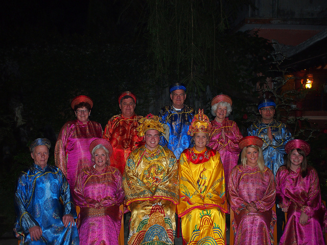 Tourists in royal custumes pose for group photos